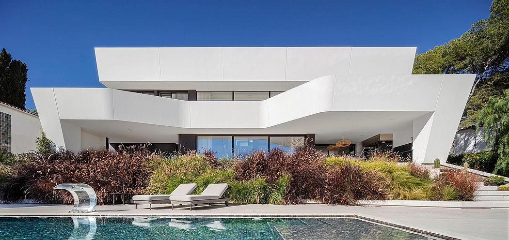 Sleek, modern architectural design with clean lines, spacious pool area, and lush landscaping.