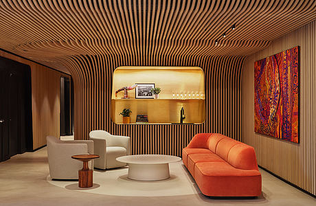 Sleek wooden slat walls and vibrant orange sofa create a warm, modern living space.