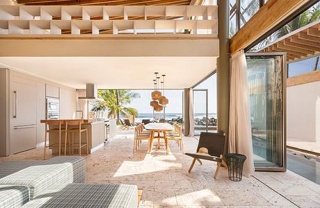 A bright, airy beach house interior with wooden accents, open layout, and stunning ocean views.