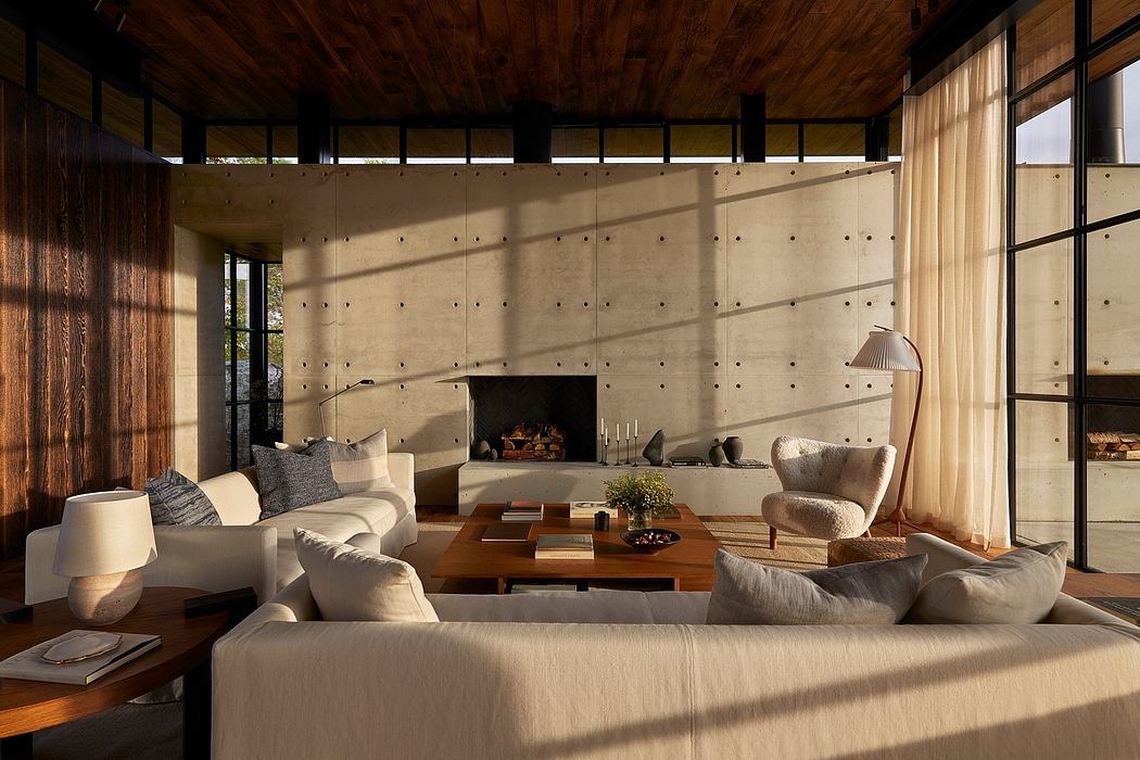 Cozy living space with textured concrete walls, wood-beamed ceiling, and plush furnishings.