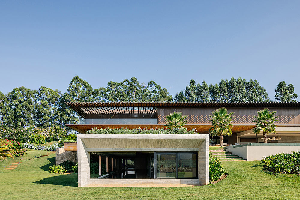 Sleek, modern architecture with clean lines, wooden roof, and lush greenery surroundings.