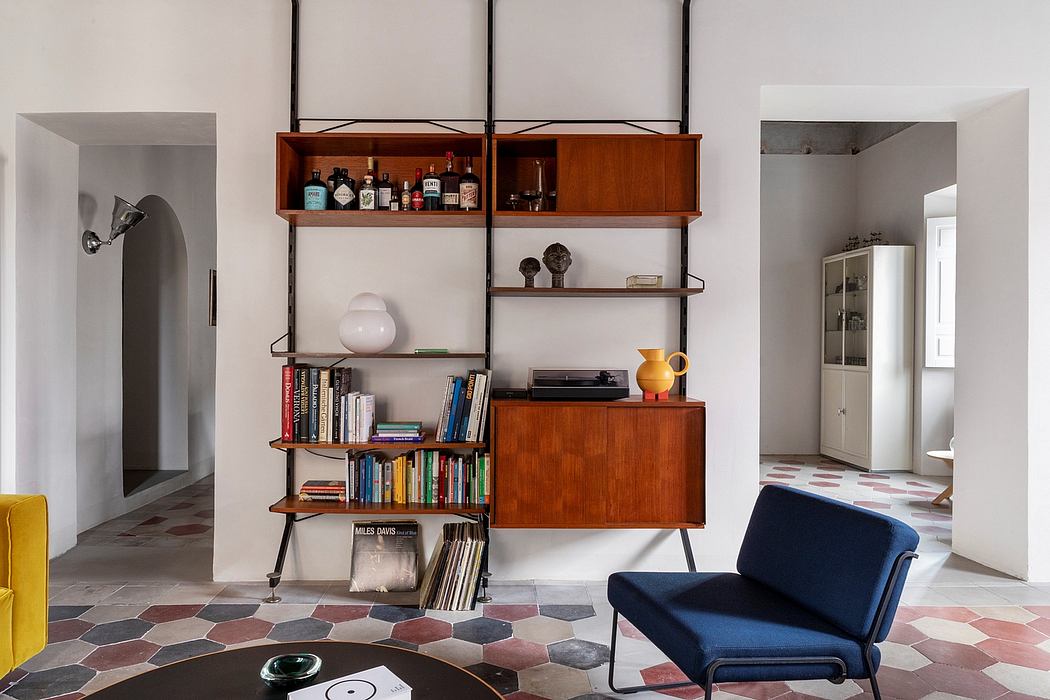 Eclectic mid-century modern living room with custom shelving, tile floors, and cozy seating.