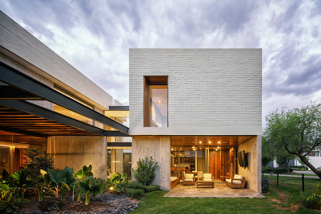 A modern, open-plan home with a wooden exterior, large windows, and lush landscaping.