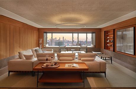 Elegant living room with panoramic city view, wooden paneling, and modern furnishings.