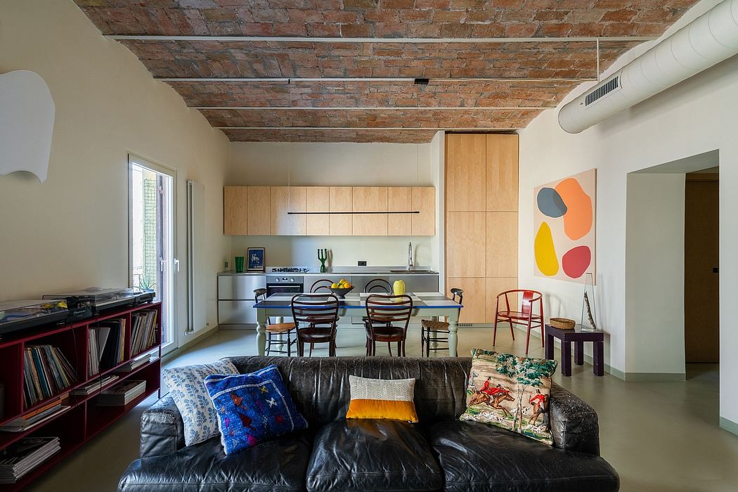 Vibrant open-concept space with exposed brick ceiling, modern kitchen, and eclectic decor.