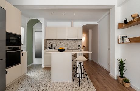 Modern kitchen with sleek cabinets, patterned backsplash, and integrated appliances on wood floors.