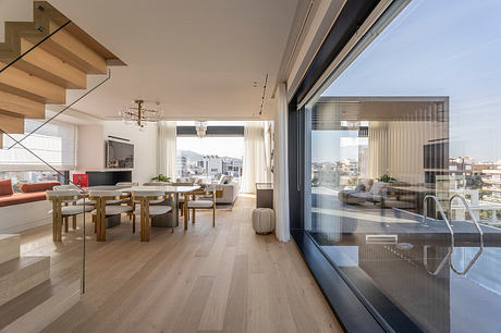 Spacious, modern apartment with wooden floors, large windows, and stylish furnishings.