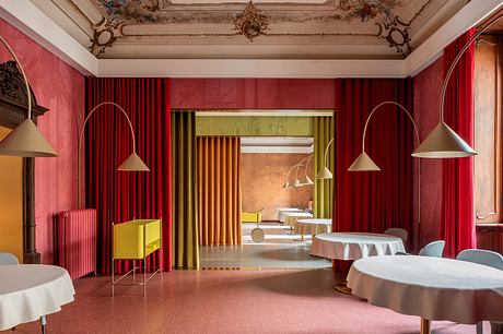 Ornate, richly-colored room with intricate architectural details and bold, modern furnishings.