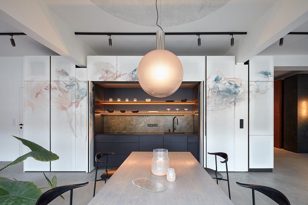 Minimalist open-plan kitchen with abstract wall panels, track lighting, and pendant globe.