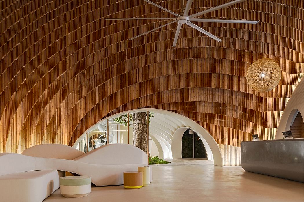 Warm-toned arched ceiling with a central fan, white furniture, and tree in the background.
