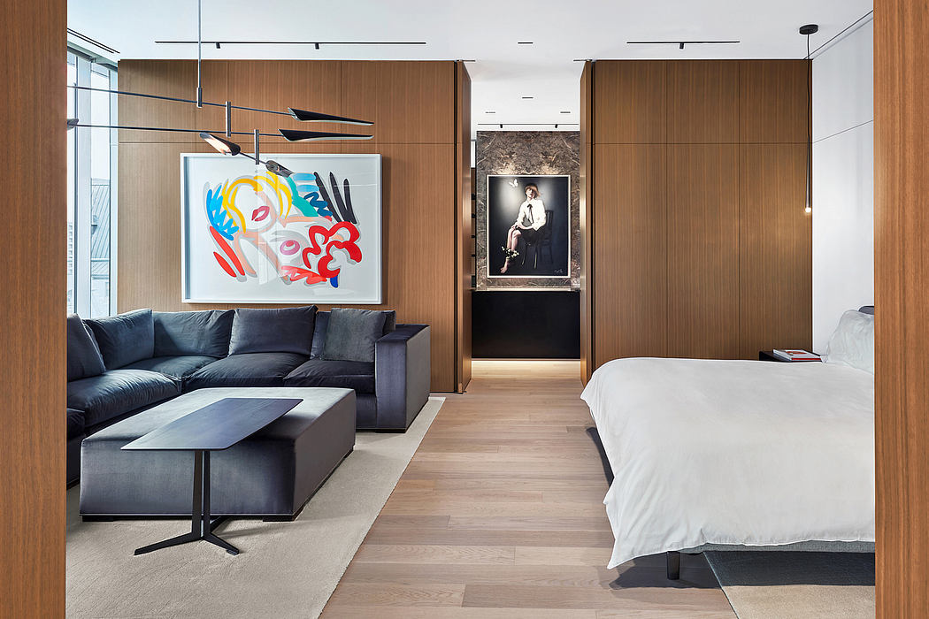 Modern open-plan living space with wooden paneling, contemporary artwork, and sleek furnishings.