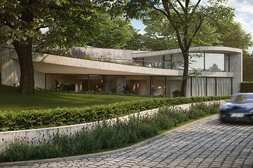 Elegant modernist residence with curved façade, lush landscaping, and cobblestone driveway.