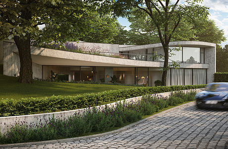 Elegant modernist residence with curved façade, lush landscaping, and cobblestone driveway.