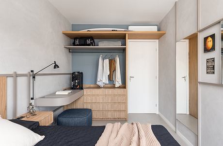 A modern, minimalist bedroom with built-in storage, wood accents, and a minimalist aesthetic.