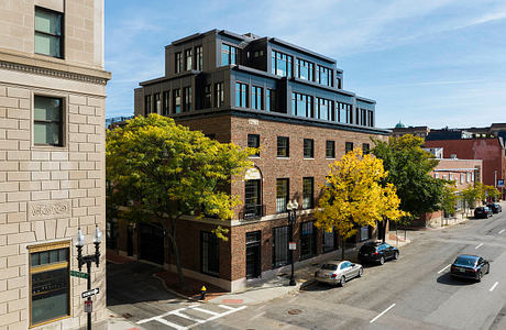 Vibrant brick building with distinctive architectural elements and warm autumn foliage.