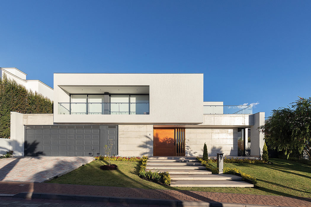 Modern, sleek exterior with clean lines, large windows, and a striking wooden entry door.