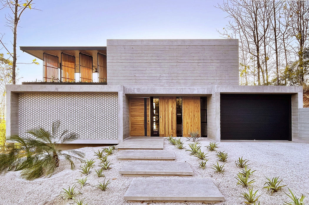 Modern concrete and wood residence with prominent entrance, garage, and balcony.