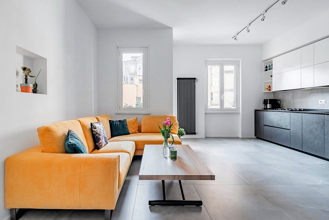 A modern, minimalist apartment with an open-plan layout, a bold orange sofa, and sleek kitchen.