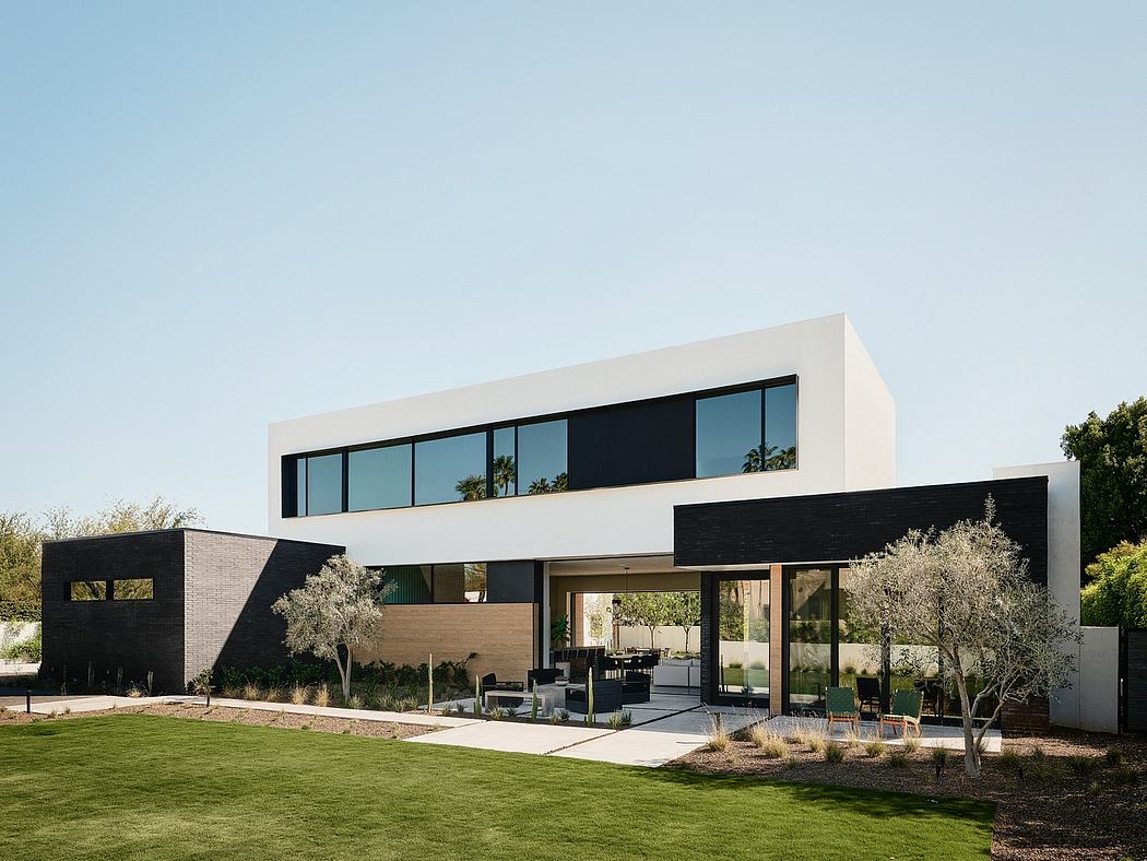 A modern, minimalist home with clean lines, large windows, and a spacious outdoor area.