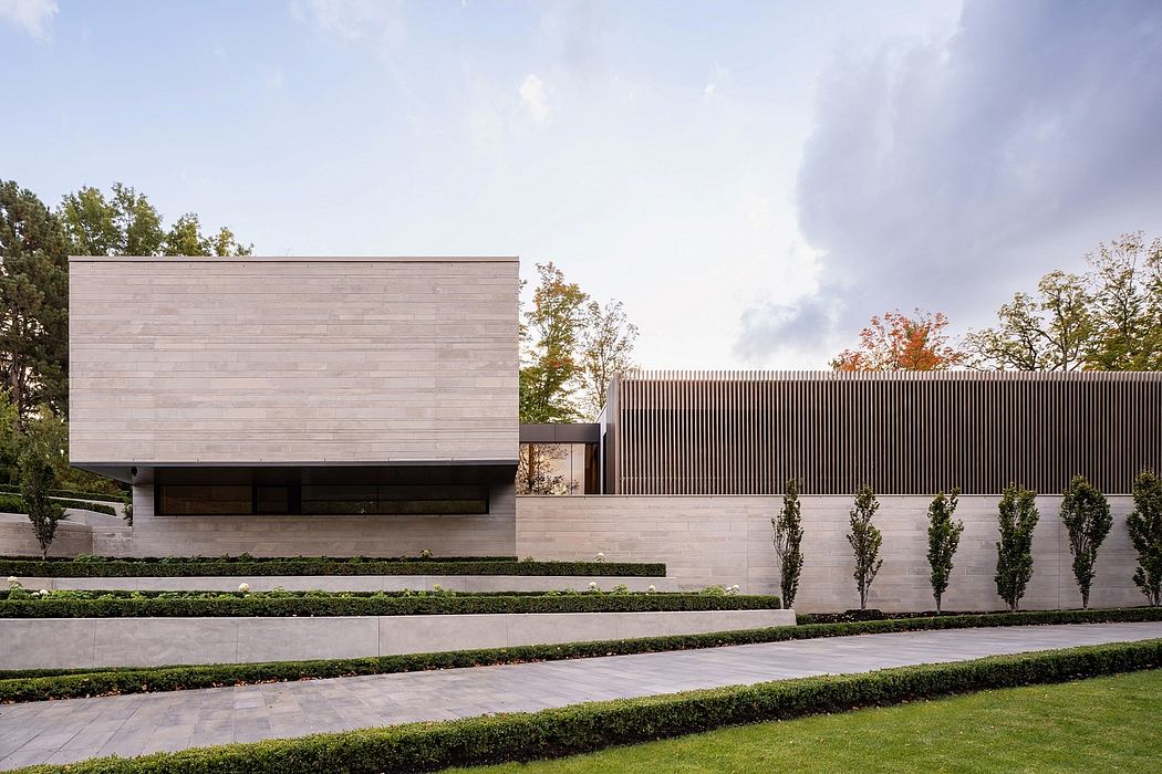 A modern architectural facade with clean lines, textured materials, and lush landscaping.