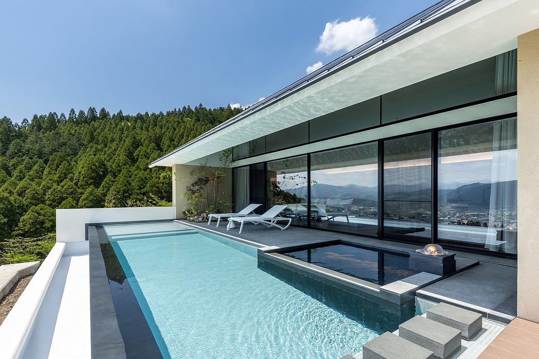 Sleek modern architecture with an expansive glass wall overlooking a scenic landscape.