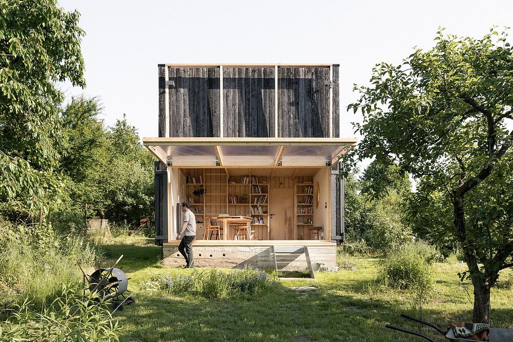 A rustic, wooden cabin-like structure with a bookshelf-lined interior and outdoor space.