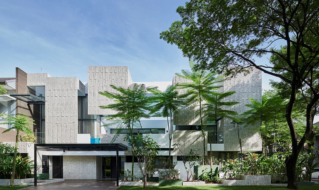 Striking modern architecture with textured concrete facades and lush tropical landscaping.