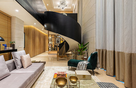 Luxurious living room with curved spiral staircase, wood paneling, and statement lighting.