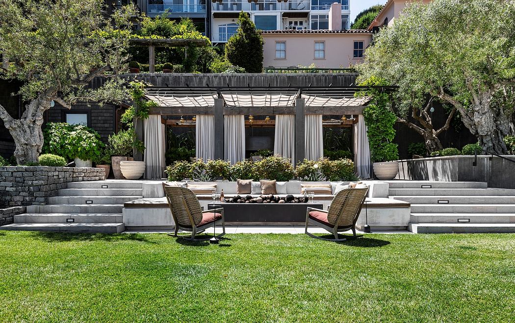 Elegant outdoor patio with stone arches, lush greenery, and plush seating.