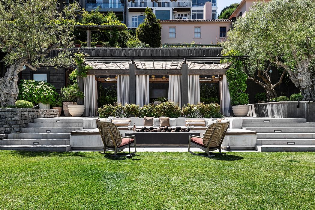 Elegant outdoor patio with stone arches, lush greenery, and plush seating.