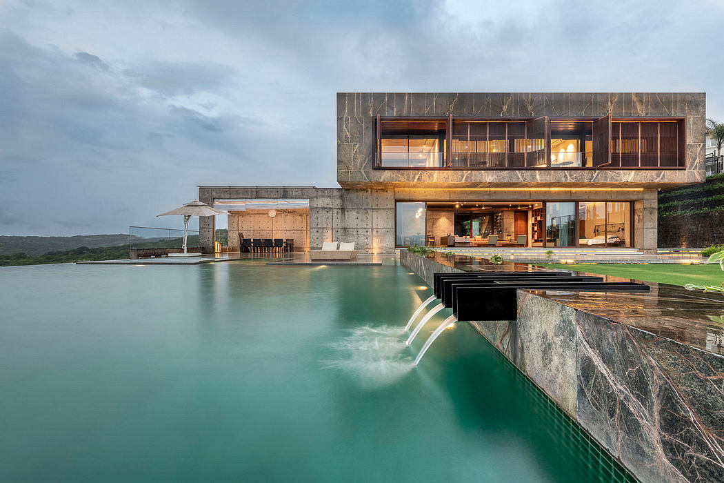 Striking modern architectural design with cantilevered levels, glass walls, and waterfall feature.