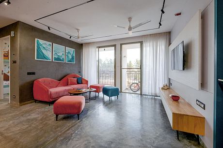 Spacious living room with modern furniture, abstract wall art, and floor-to-ceiling windows.