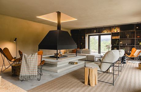 Cozy modern living room with sleek fireplace, built-in shelving, and natural textures.