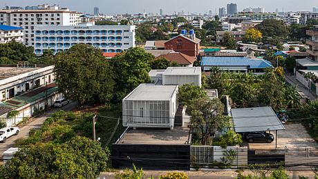 Vibrant cityscape with diverse architectural styles, including modern glass structures and traditional brick buildings.