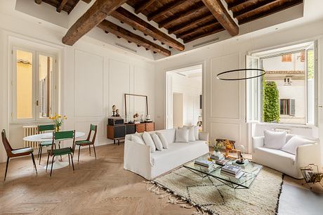 Bright, modern living space with exposed wooden beams and distinctive furnishings.