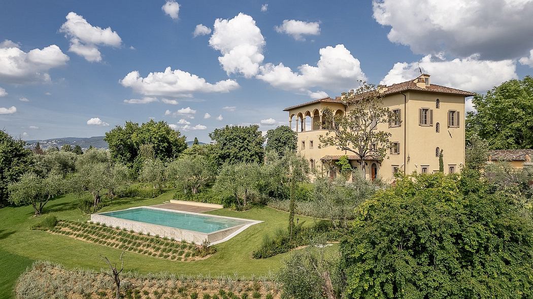 Charming Italian villa surrounded by lush gardens and a swimming pool.