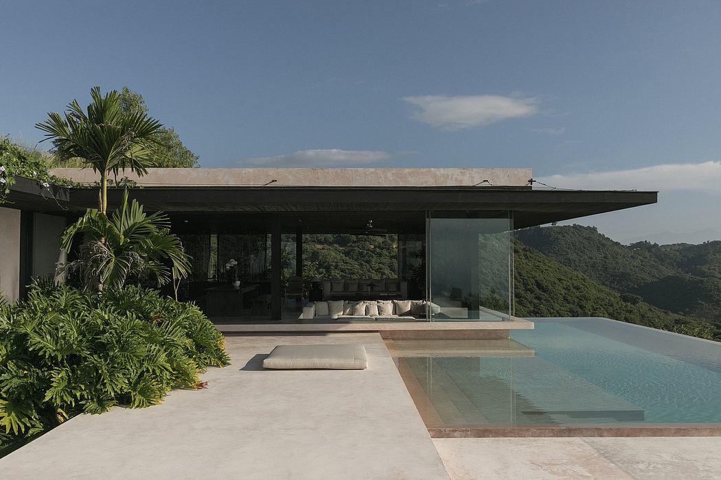 Sleek modern villa with open-concept design, infinity pool, and lush tropical surroundings.