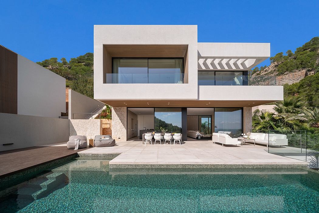Sleek modern villa with minimalist architecture, expansive glass walls, and an infinity pool.