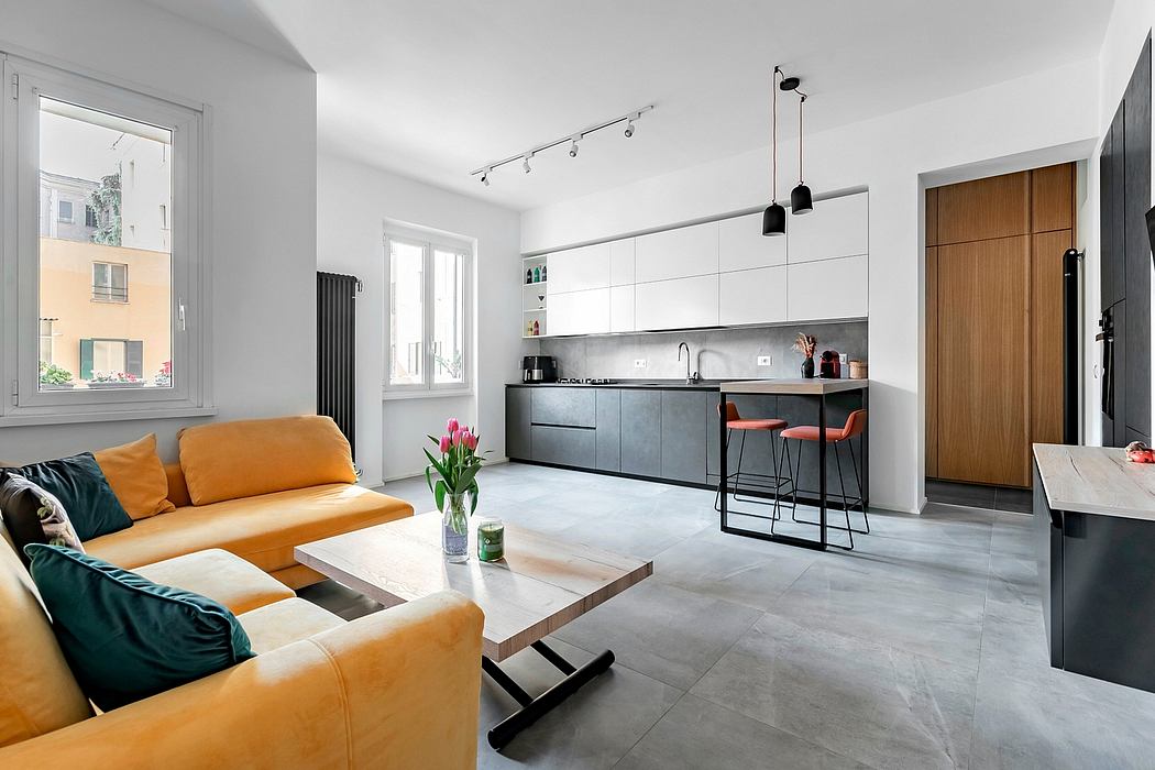 A modern, open-concept apartment with sleek gray cabinetry, wooden accents, and a vibrant yellow sofa.