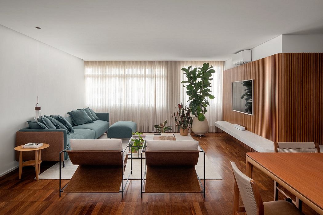 Spacious modern living room with wood paneling, greenery, and minimalist furniture.
