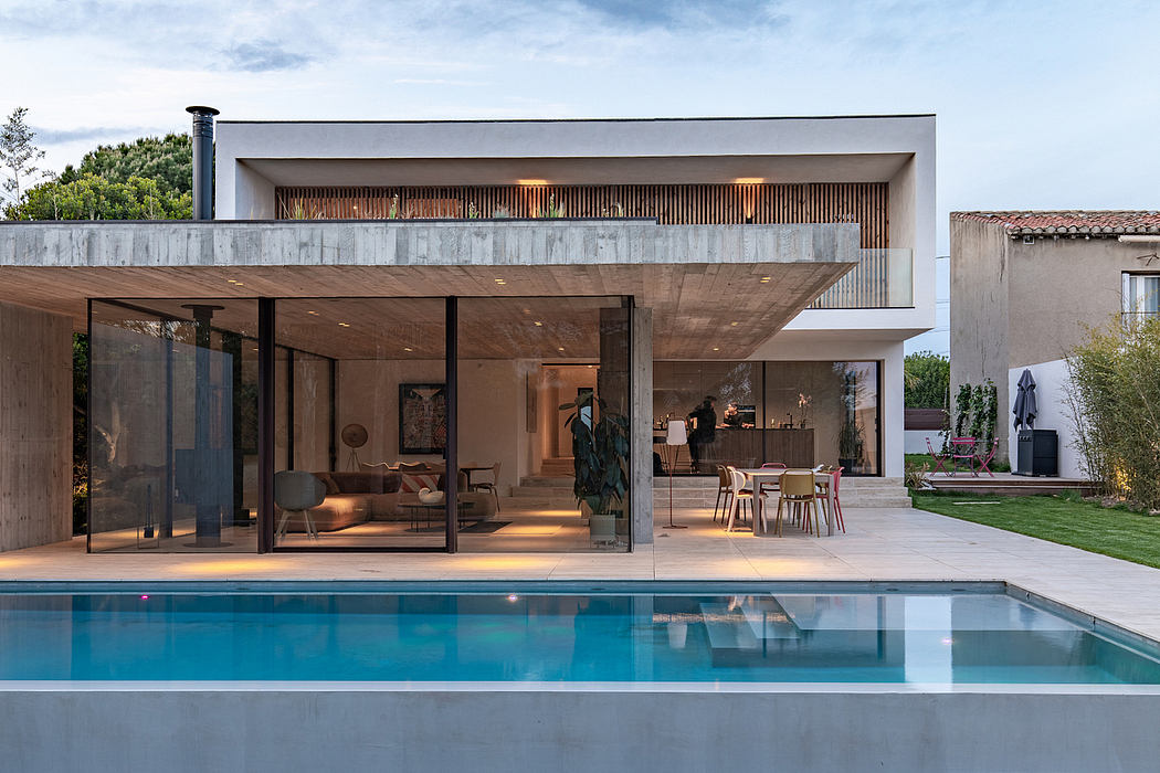 Sleek, modern home with open floor plan, pool, and covered outdoor living area.