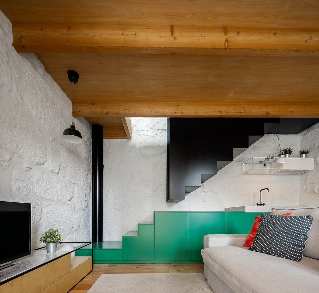 A modern, minimalist interior with a wooden ceiling, white walls, and a bright green staircase.