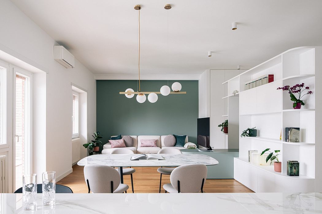 Elegant modern living room with statement lighting fixture and minimalist shelving.