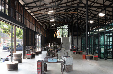 Large open industrial space with metal framing, exposed ceilings, and vintage decor.