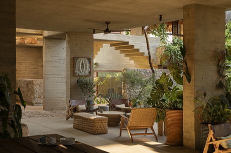 Cozy covered outdoor living area with rustic wooden architecture, natural materials.