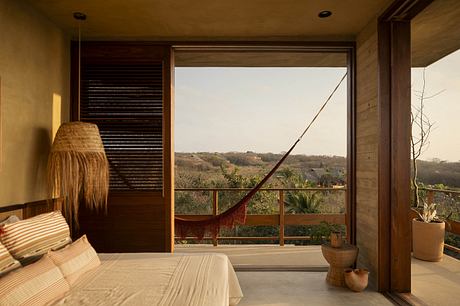 Expansive view from a warm, rustic bedroom with wood paneling and woven decor.