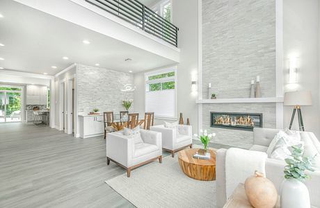 Bright, modern living room with sleek fireplace, high ceilings, and ample natural light.