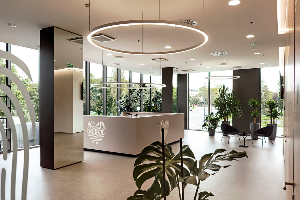 Sleek, modern lobby with circular lights, lush plants, and minimalist seating.