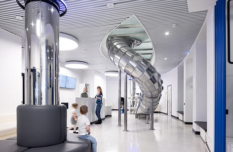 Striking modern interior with spiral slide, sleek fixtures, and interactive elements.