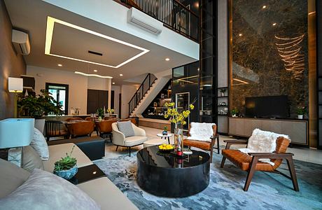 A modern, spacious living room with a sleek design, warm lighting, and a mix of natural and industrial elements.